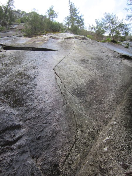 Pitch 1. It had rained the night before. The entire route was dry enough to climb despite the water streaks beside it at the base.