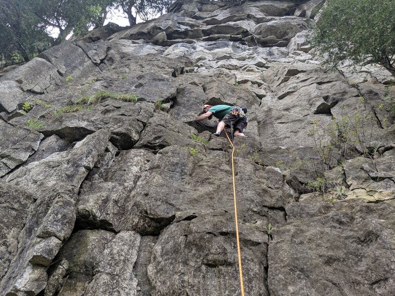 First bolt is just above a ledge, relatively easily reached with a scramble on climber's right if you want to pre-clip.