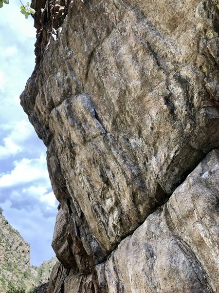 The route climbs through the lieback jug at mid-height.