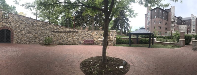 This photo shows the entrance (on the right of the photo) and the rest of the wall and patio.