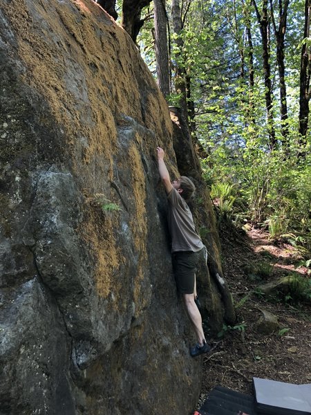 Isaac Lee reaches for the ledge on Gumby Slab