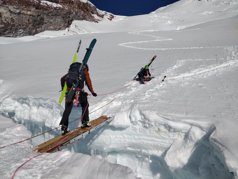 Crevasse crossing about a third of the way up the route. Ladders are fairly stable but it's still a bit scary to walk across this gap<br>
<br>
Taken on 5/29/19
