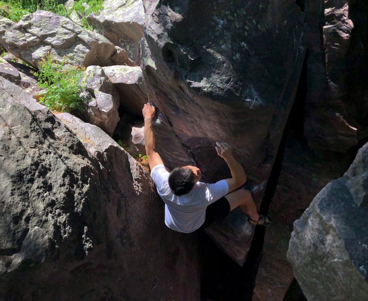 Brandon Wiley past the crux and pulling through the top half of the route