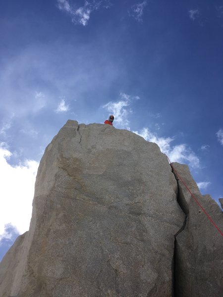Peter Throckmorton on the summit with rope following the path of the final 5.7 moves onto the top! Pic: Audrey Adler