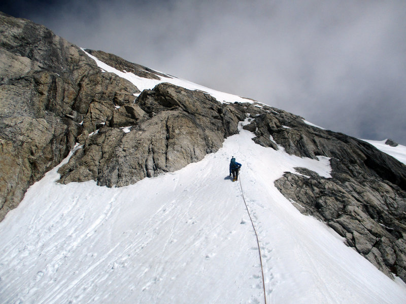 John leading out of the col over the cl. 3 slabs to access the summit snowfield.