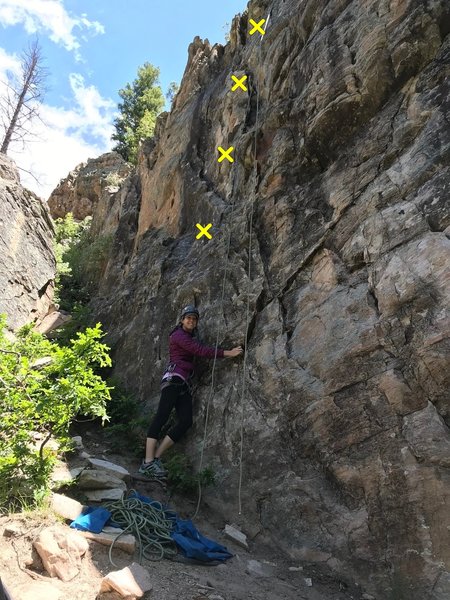 "Fun For The Whole Family" location photo. Rope is hanging from the anchor and Mandy is directly under the bolt line.