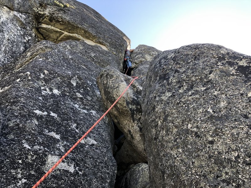 Justin Ling leading the seldom-climbed 3rd pitch to the top of an airy pinnacle. I thought the face just right of the offwidth crack was easier to climb.