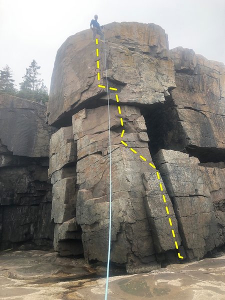The route starts just left of the off-width ( on right side of photo). Move up the face to the obvious stances, then angle up and left to a stance on the arête. Move up to the overhang, pull yourself up, then finish up either face. That's how I did it.