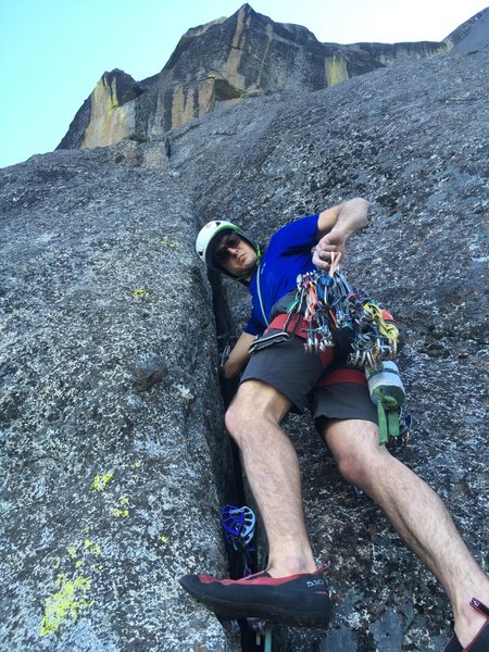 Paul leading up the wide crack on P2.