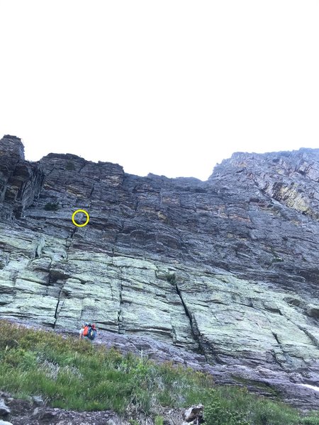 Looking up from the grassy ledge. Just left of Jason is the bottom of the starting crack system; note the flare with the handcrack up above him that's the big marker for pitch 1.