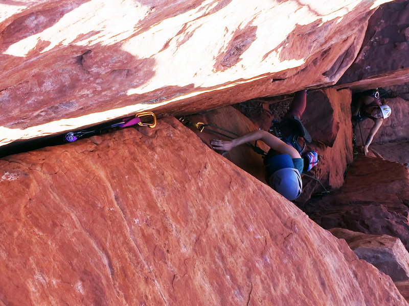 India coming up to the summit via the double cracks. Note big ledges out high and right. You'll need these to make the "roof move" easier.