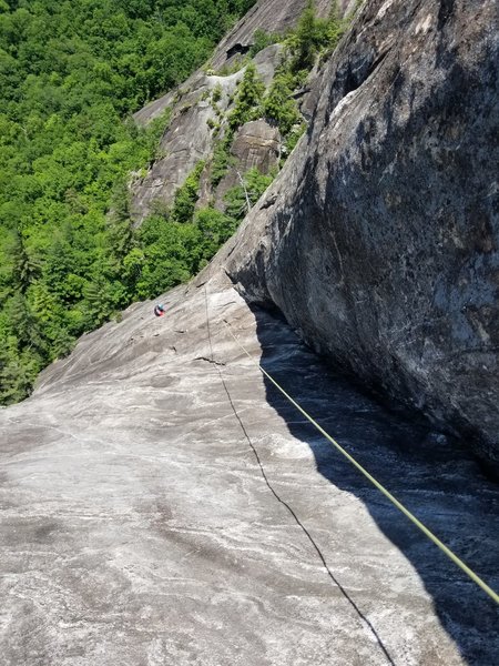 Go as high as you can before the down climb/traverse pitch