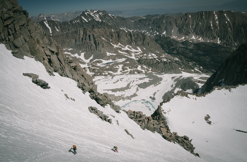 Two climbers headed up the L shaped couloir on the way to the base of Swiss Arete