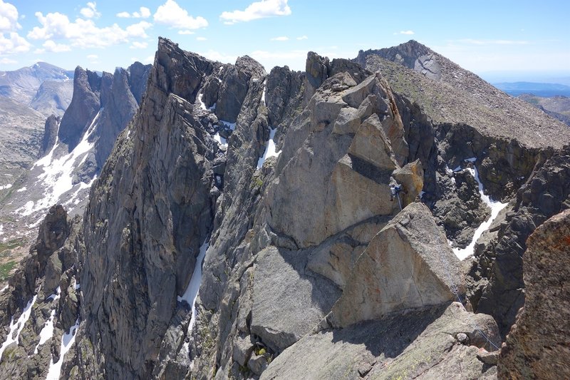 Casey on crux "5.8" move on traverse between N and S Summits. This is an exposed pitch. Both leader and follower need to be solid.