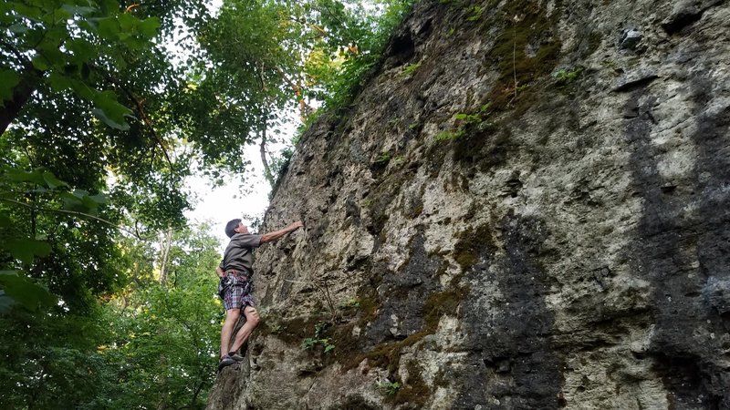 Jim enjoying the ledge and eyeing up the moves to the anchors