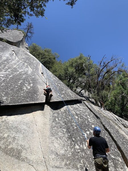 Using the large crack as "side jugs" with both hands to ull up