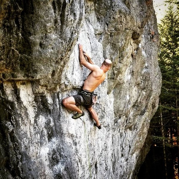 Looking for the next hold just after the crux on Rainy Day Woman