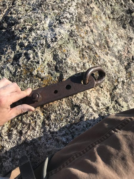 The a fore mentioned "nasty old rusty piece of crap metal chunk". It's very bulky and total overkill by the way. The square piece of metal is a solid 3/8" thick, with a 1/2" bolt going into the rock. the patina of rust does not inspire confidence though.