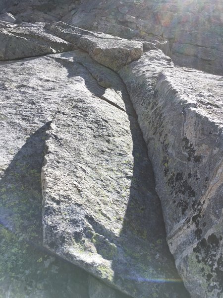 Just below the big ledge ~90% up. There might have been an easier way up nearby, but not as aesthetic. It's as clean as it looks and is very fun. In difficulty and angle it reminded me of a layback variation of p1 Direct E Face 5.6 on the First Flatiron.