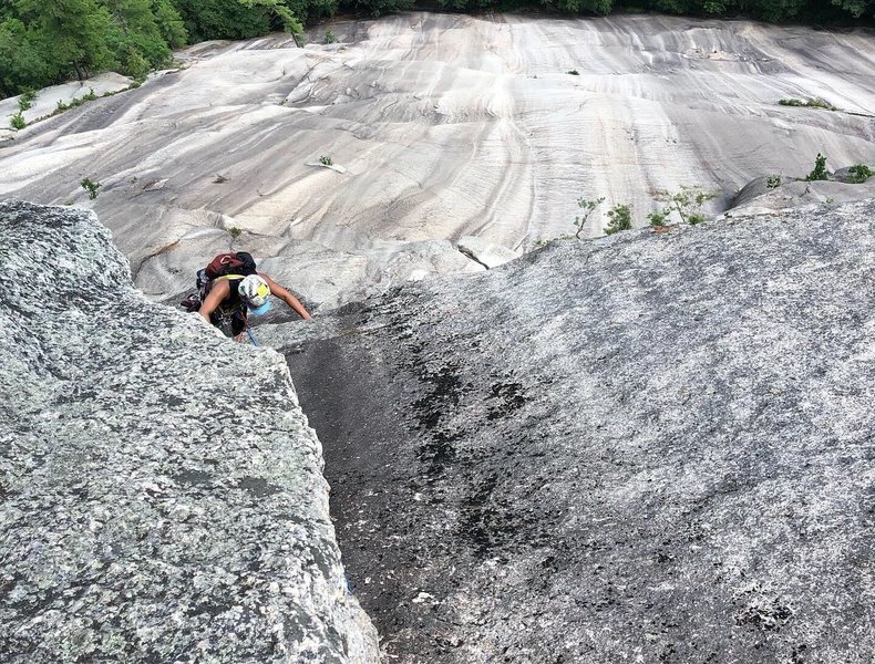 Jean cruising up the last moves of P4 to the comfy belay ledge!