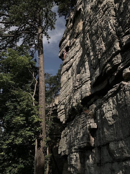 Rounding the "pole" (arete) below the roof, a fun move with good exposure.