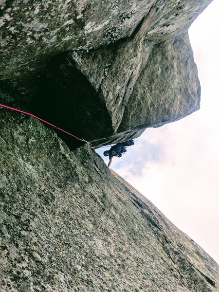 Getting established in the Diheadral after clearing the awkward crux roof at the start of pitch 2