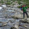Happy kid crossing a stream on way out of Titcomb Basin.