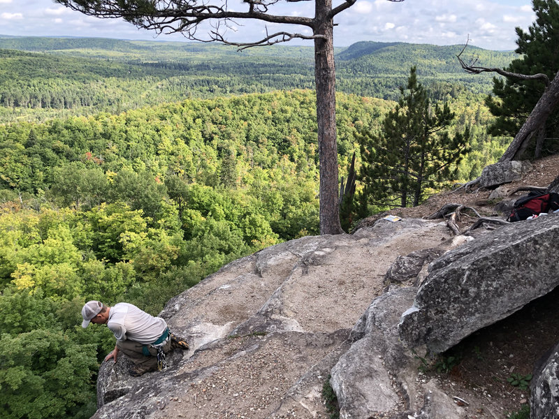 Top of Sawmill Creek Dome. Conner looking over edge. Top of Birch Flakes is right by the big tree in center of photo.