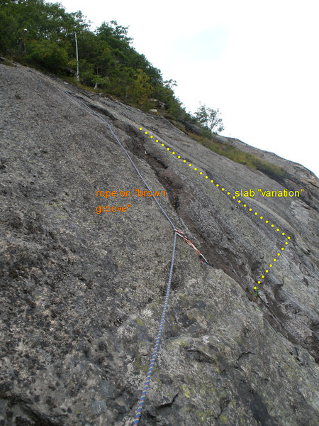 About 1/2 way along the P4 traverse. The "brown groove" starts at the protection. Or you can move left and climb directly up the slab beyond.