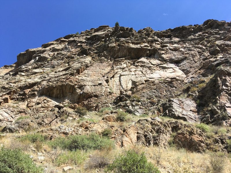 A view of the crag from the bike path. The climber in the middle of the photo is on Reincarnation.