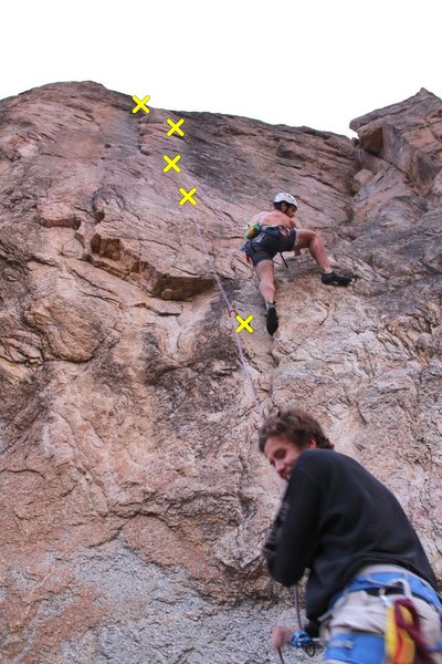 Crack up, traverse left on good feet, and up the crack system to the top.