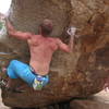 Dave McAllister starting Arete on the Cosmic Friction Boulder in Hampi, India.