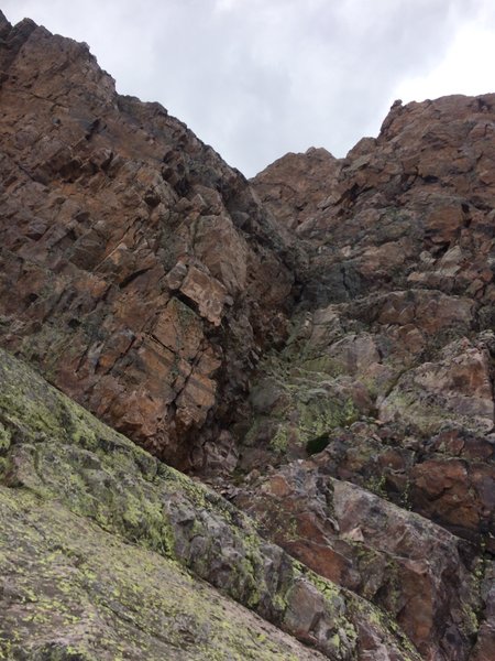 This is the weakness we scrambled up from the ramp to get to the high ridge line and false summit. My suggestion is to continue further up the ramp before finding a way up closer to the false summit.