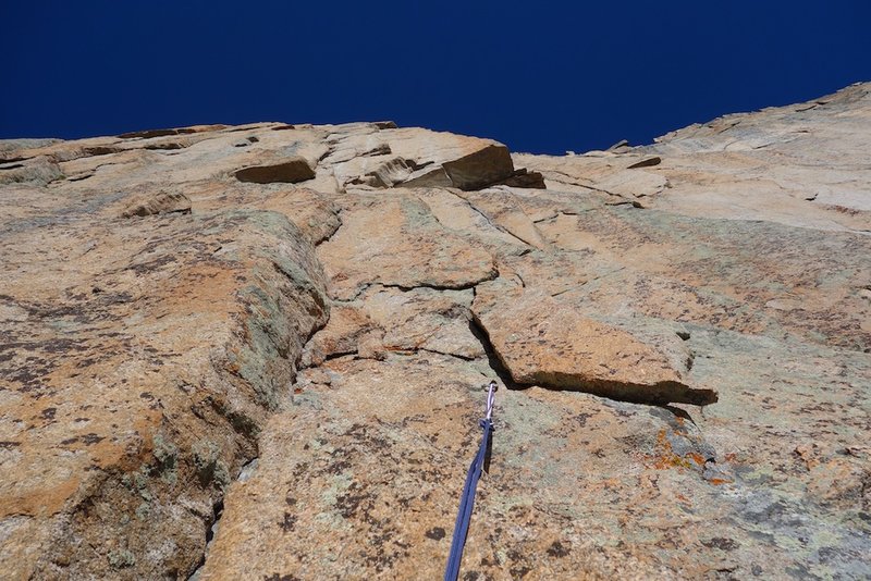 Looking up pitch 4. The crux roof looms above.