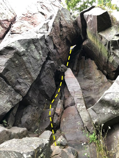 Climb to the left and behind the prominent shaft, up through the hole, and continue on to the top.