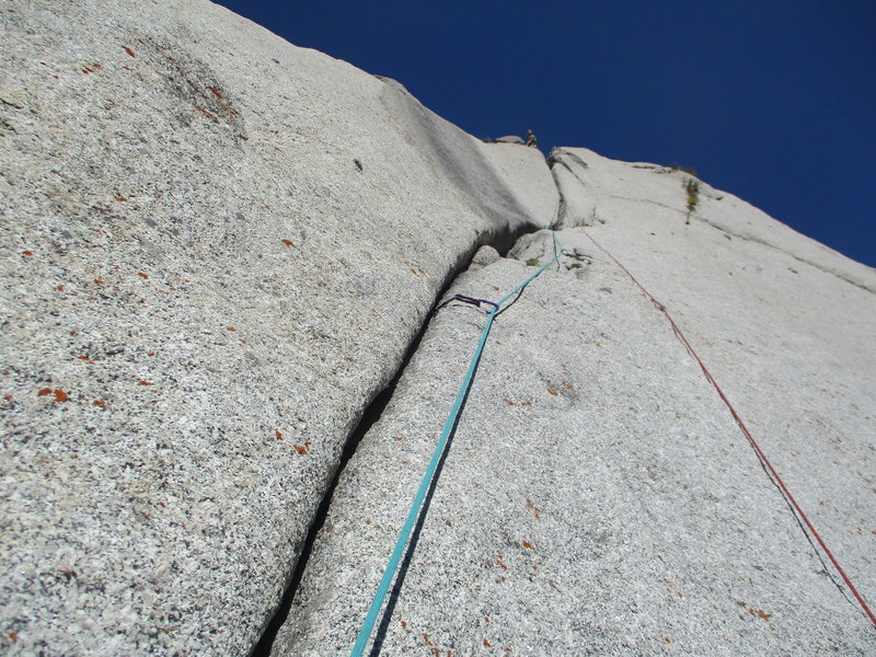 Following up P4. Chad is at the anchors. The first section with tricky pro has a mysterious single bolt on the right to clip. Climbing it was very easy since the angle was very flat.