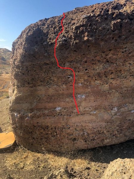 Match a big hold at the bottom and twistlock your hips all the way up gracefully whilst minding the boulder that would ruin your week if fallen upon and left unpadded. High left foot at the top getting over the ledge