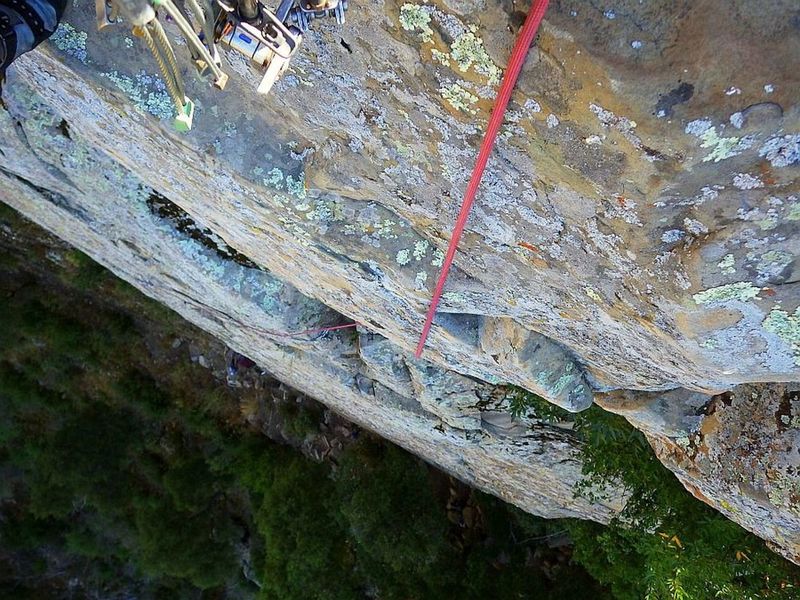 Leading up and over the big summit roof, veering left toward the anchor bolts, with Caiti way below. 15 Oct 2019.