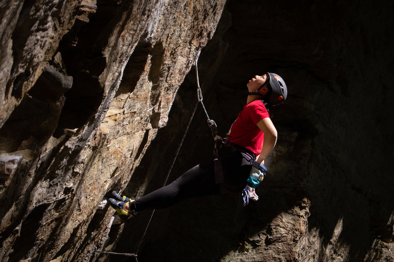 Shu taking a break and eyeing up the crux.