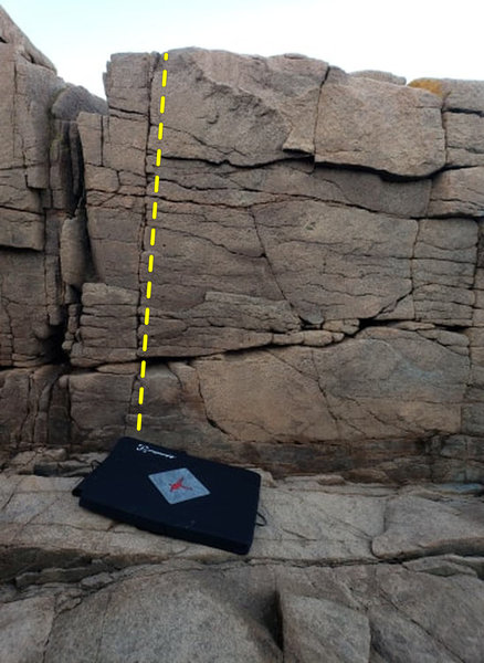 Follow the crack up from the upper left corner of the mat, just left of the topo. Reach for the topout.