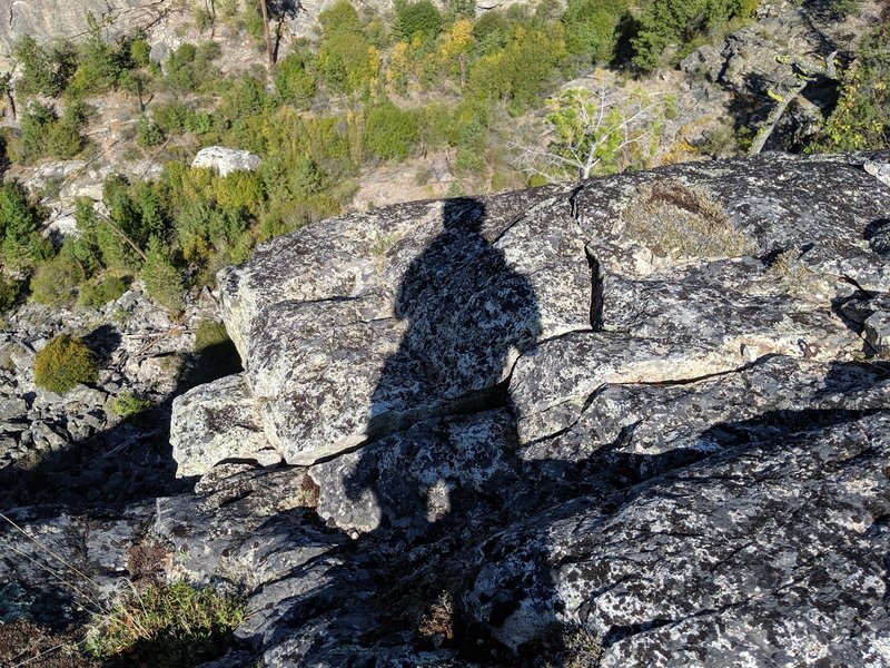 The top of P2 of Mrs. Palmer. The roof exist is on the left. A singly rusty piton on the right, which can be easily backed up.