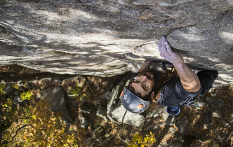 Pulling the top-out moves on the OS.
<br>
Photo: Alex Beld