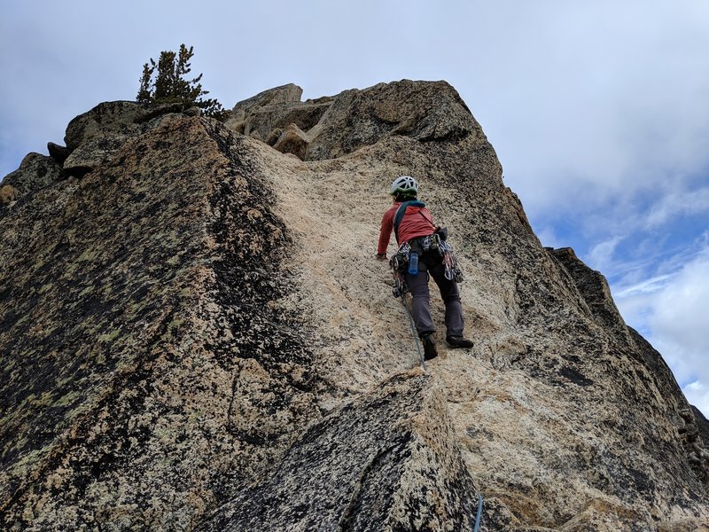 Looking up at the slab boulder problem on the final pitch of the Beckey Route