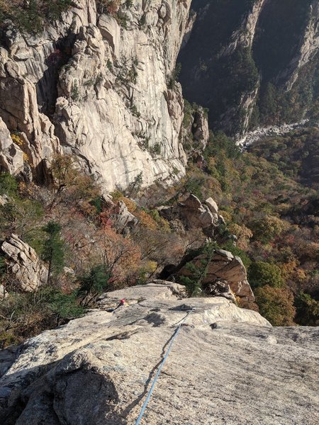 Looking down on P3 midway up. Jungunbong SW wall lurks behind.