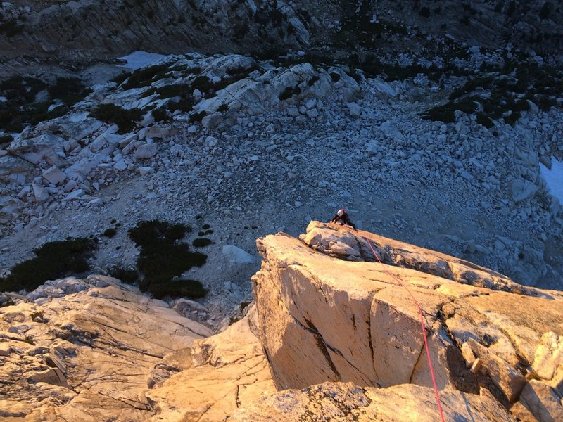 Finishing up the airy arete during golden hour, Pitch 3<br>
Photo doesn't do the exposure justice