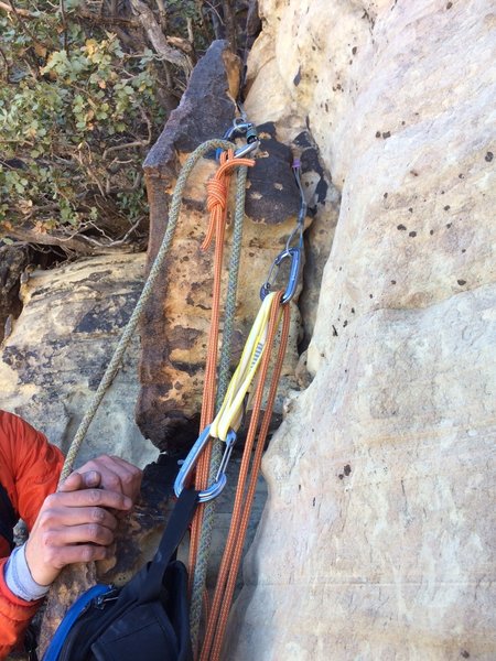 Anchor at the top of P4, stepping right after the final crux move. Guidebook says to continue up another 20 ft or so of this arete and build the anchor level with the big roof but that stance looked less than inspiring. This allowed more room for 2 people