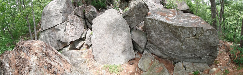 The backside of the Buried Treasure boulder (right), Tombstone boulder (center), and the Mullet Wall (left).