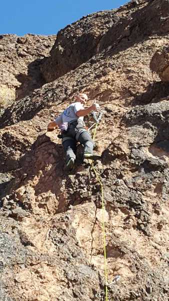 Using that single large biner to rappel down.