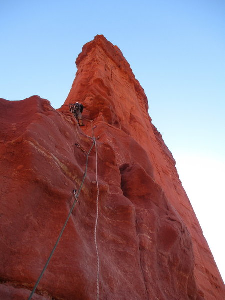 Dirk at the end of the bolt ladder on P3, about to begin the mixed 5.7 free and C2 aid climbing to reach the lower anchor.