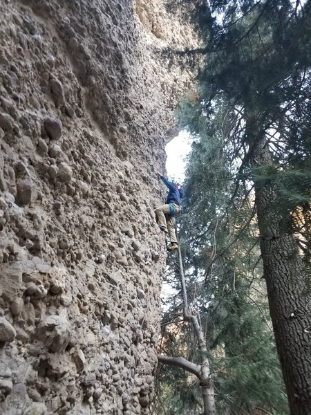 Aj about to go around the corner at the crux.